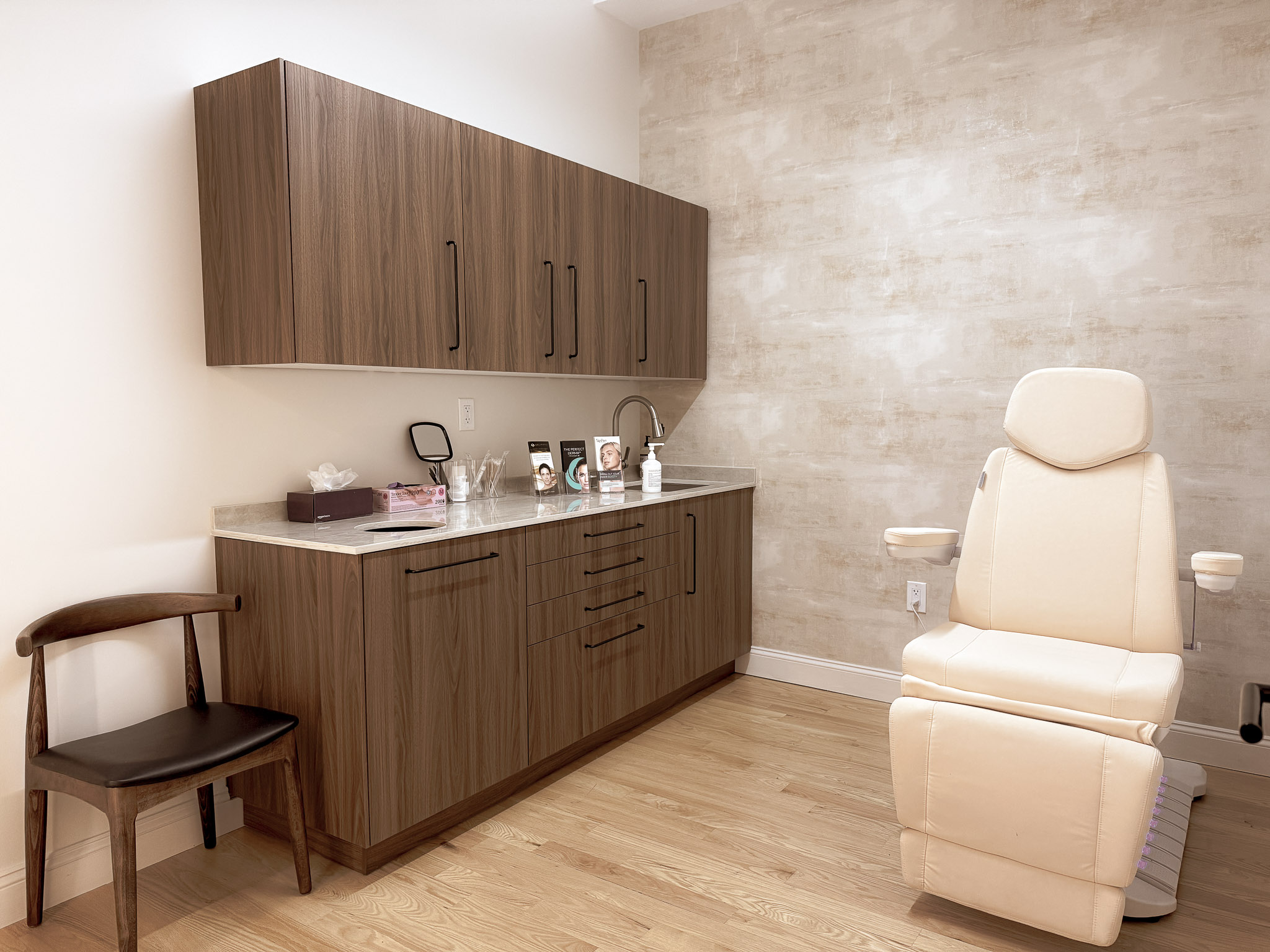 Luxurious treatment room with cream medical chair, natural lighting, and spa-like ambiance